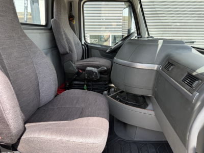 Interior of a 2019 Volvo VNL300 truck cab showing two gray seats, steering wheel, and dashboard.