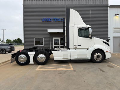 Side view of a white 2019 Volvo VNL300 conventional daycab tractor parked outside a used truck dealership. VIN 4V4NC9EH5KN199055, stock B3451P visible.