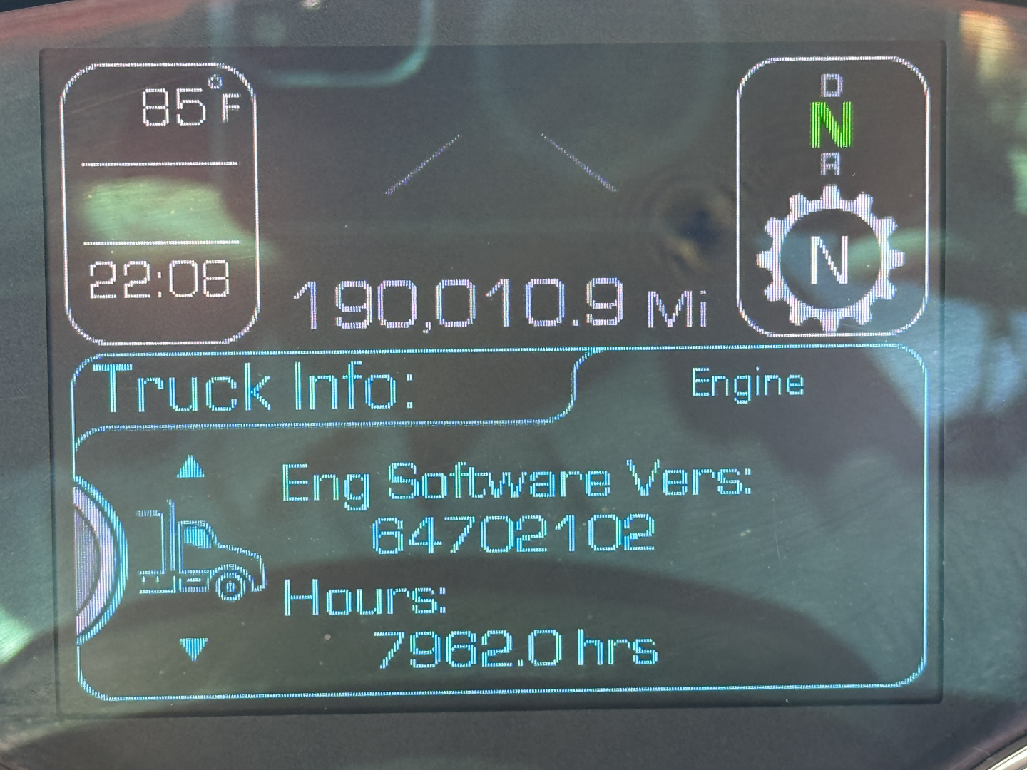 Kenworth T680 truck dashboard display showing 190,010.9 miles, engine hours 7962.0, Eng Software Vers: 64702102, and truck info icon.