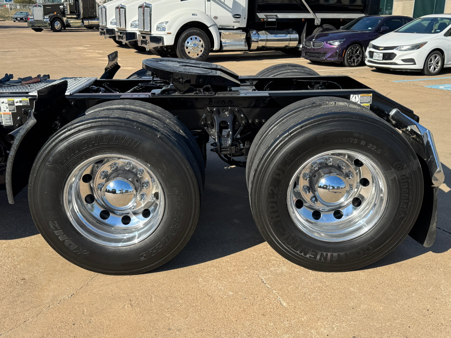 Kenworth T680 chassis with dual rear axles and chrome wheels, front view of the rear wheels and frame