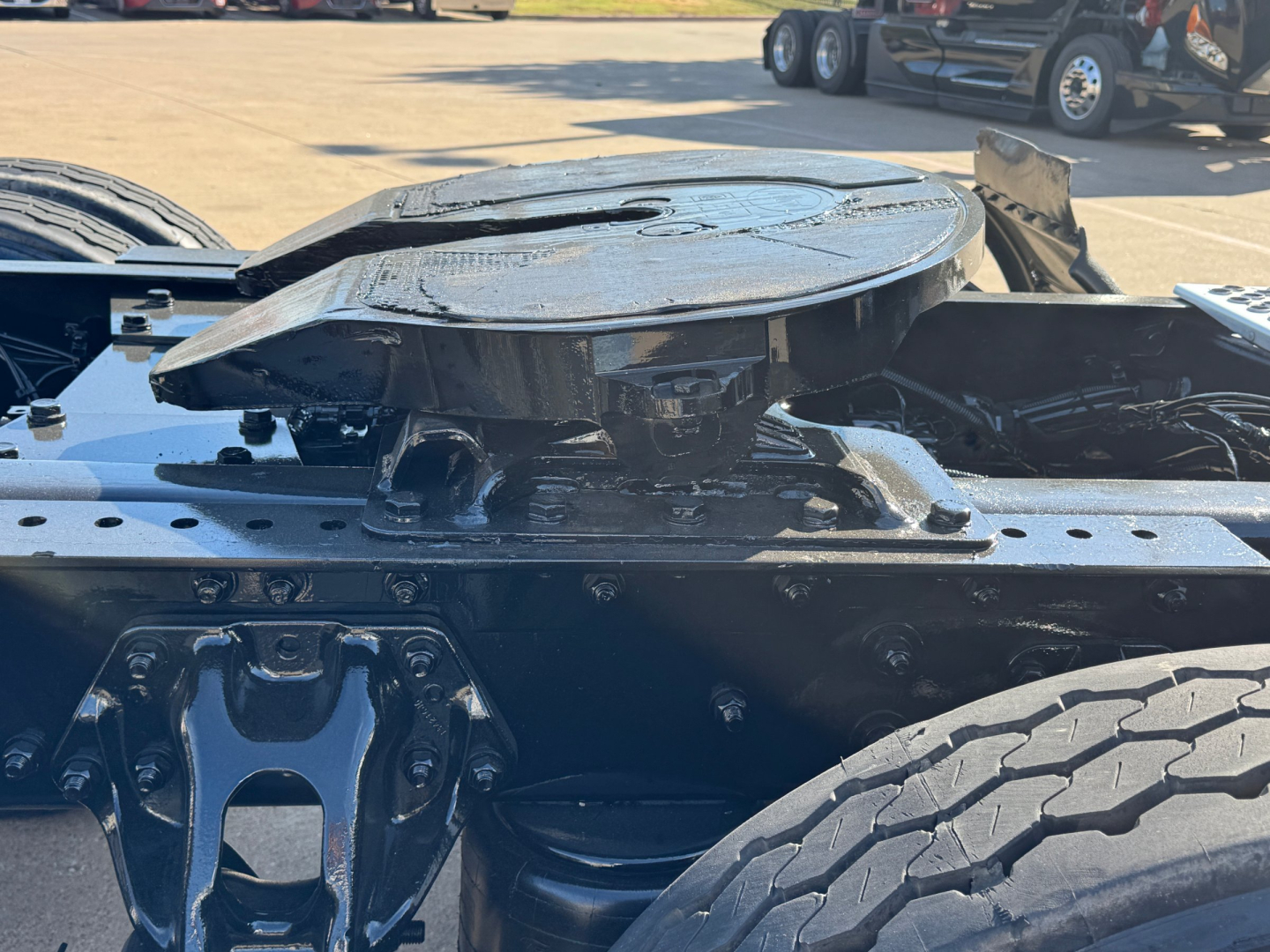 Kenworth T680 truck chassis top view showing fifth wheel hitch and landing gear area with tire visible on right.