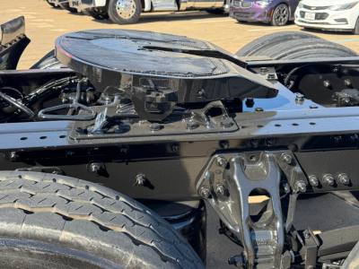 Kenworth truck chassis and fifth wheel mount with visible suspension and frame components.