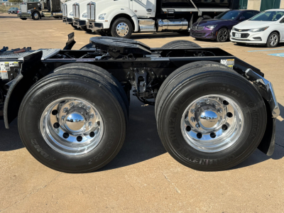 Kenworth T680 chassis with dual rear axles and chrome wheels, front view of the rear wheels and frame