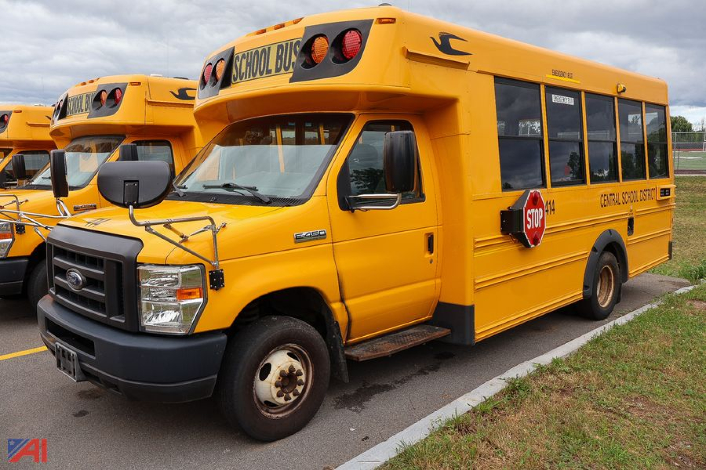1999 Ford Blue Bird E-Series school bus in yellow with stop sign, side text, and front grille.