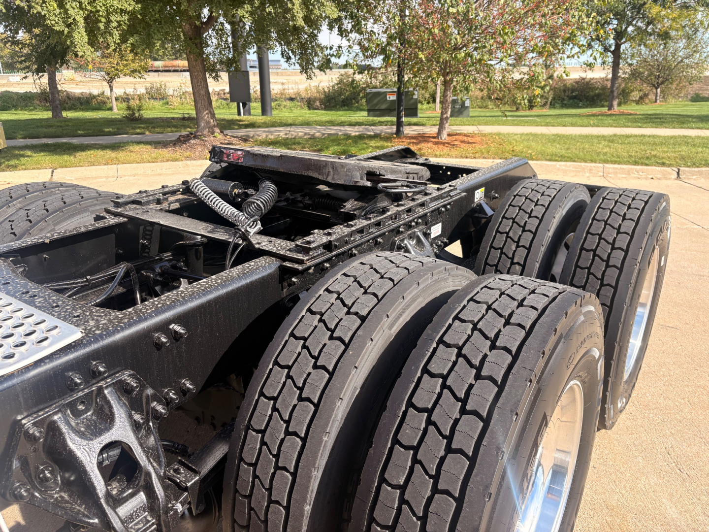 Kenworth T680 chassis and dual rear axles/view of wheel assembIes with tires and undercarriage showing framing and connectors