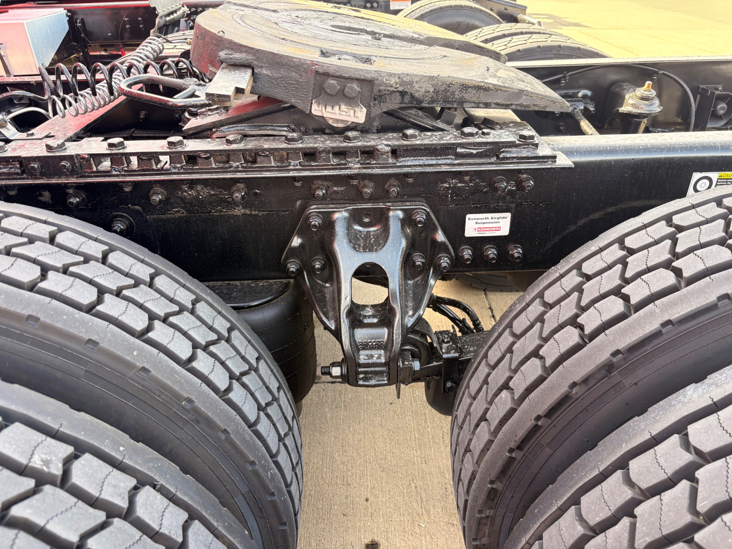 Kenworth T680 truck chassis with rear suspension and dual rear axles, showing the fifth wheel mounting and frame members.