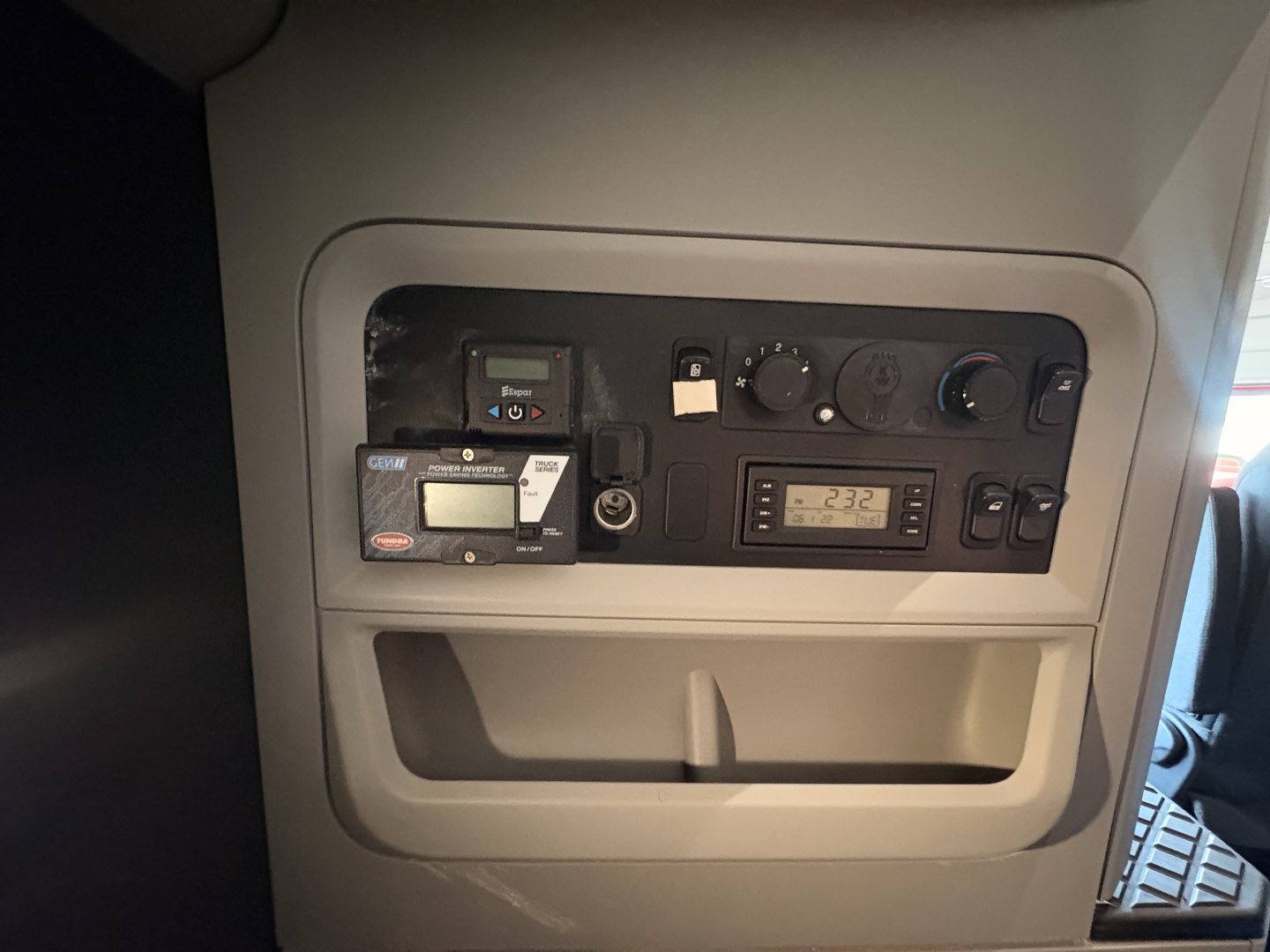 Kenworth truck interior dash panel showing control gauges and digital readout.