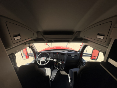 Kenworth T680 truck interior cab dash and steering wheel view from cockpit with dashboard controls and sleeper area