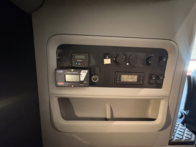 Kenworth truck interior dash panel showing control gauges and digital readout.