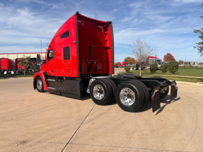 Kenworth T680 conventional sleeper truck side profile showing red cab and dual rear axles.