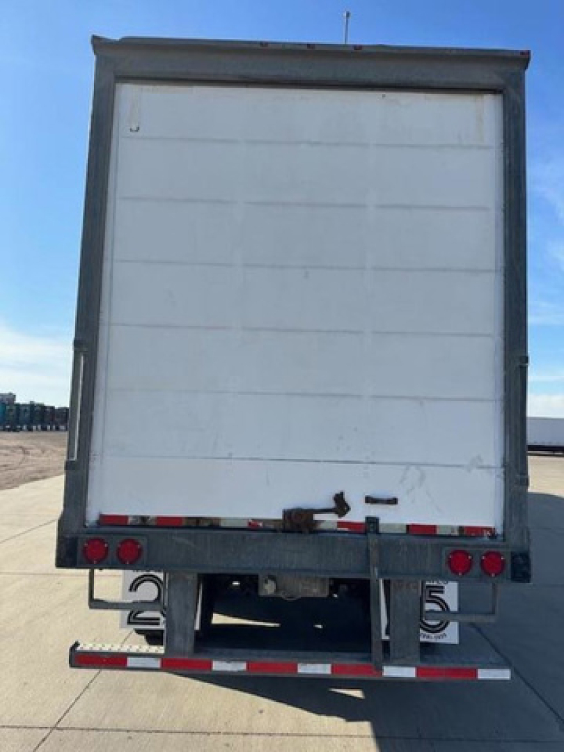 Rear view of a white Wabash trailer van showing the back doors, bumper structure, and license plate area; no legible text visible on the doors.