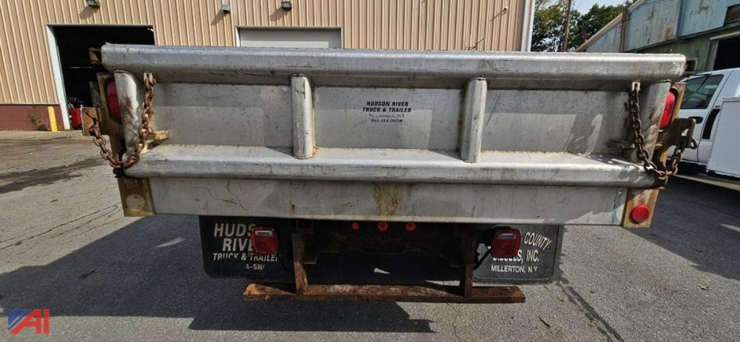 Truck bed of a 2008 GMC Sierra 3500HD with plow showing rear dump bed, tailgate chains, bumper, and license plate area.