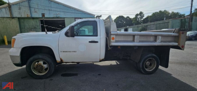 GMC Sierra 3500HD flatbed dump truck side view showing utility bed and plow prep with rear dump bed.