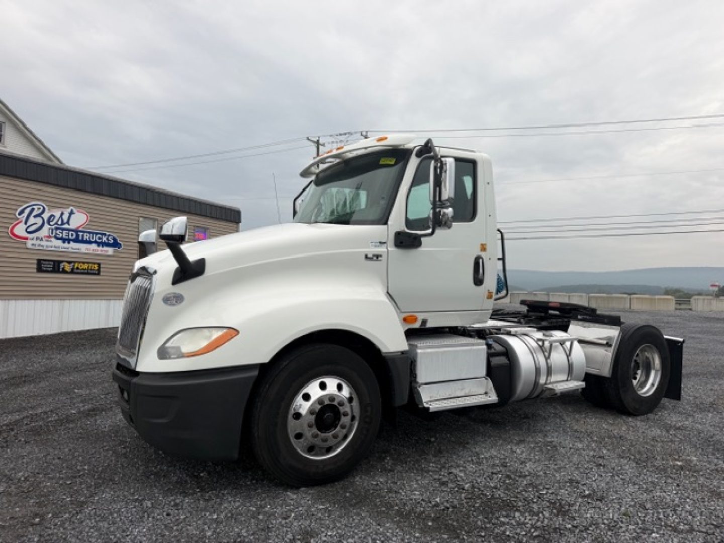 2018 International LT625 conventional daycab truck side view showing diesel fuel tanks and cab details