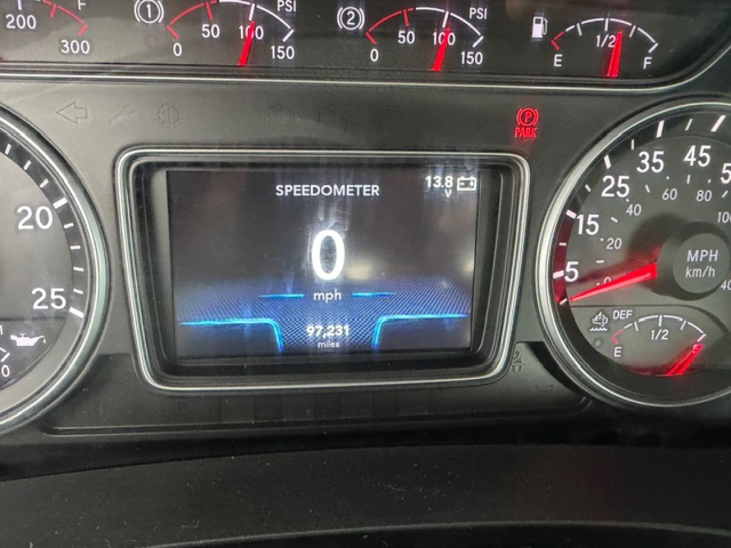 Dashboard of 2018 International LT625 showing speedometer at 0 mph, digital display reading SPEEDOMETER 0 mph with 97,231 miles, and other gauges.