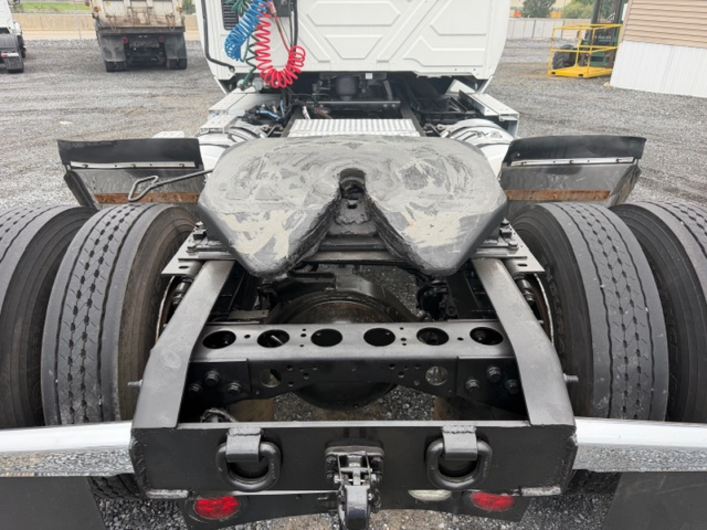 Truck chassis and fifth wheel area of a 2018 International LT625 conventional daycab showing rear dual rear wheels and mounting frame.