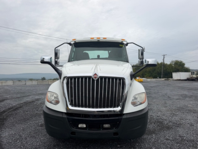 Truck front view of a 2018 International LT625 conventional daycab with large chrome grille, white cab, and black bumper.
