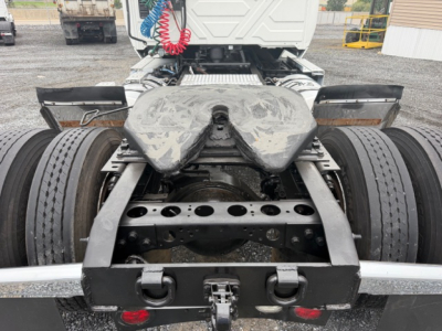 Truck chassis and fifth wheel area of a 2018 International LT625 conventional daycab showing rear dual rear wheels and mounting frame.