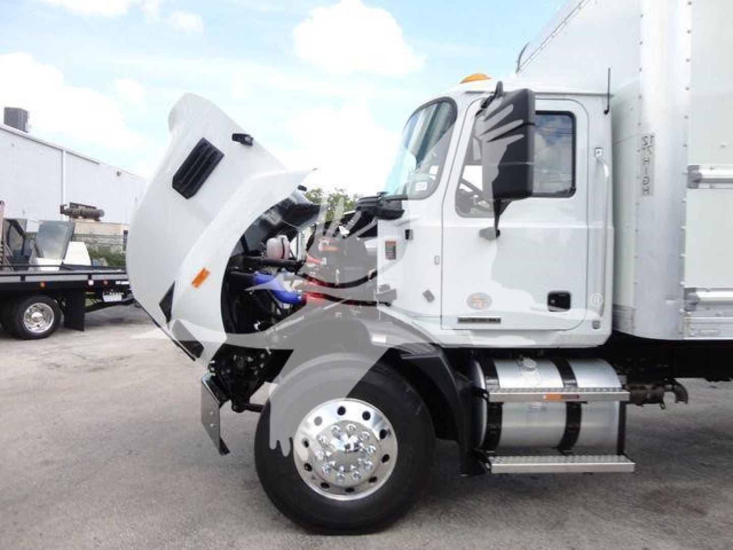 MD6 truck cab with hood open revealing engine bay and front wheel passenger-side view.