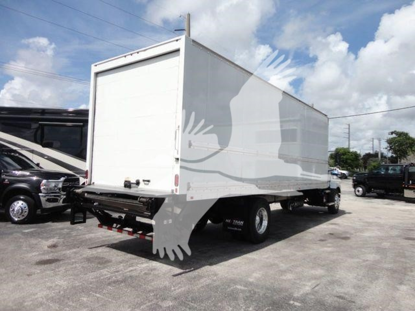 Box truck trailer showing rear and side, no legible text visible on exterior in this view.