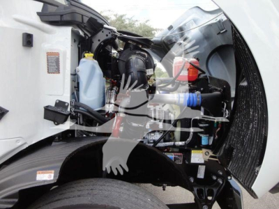 Engine bay of a 2026 Mack MD6 showing components and fluid reservoirs visible in the front-left side.