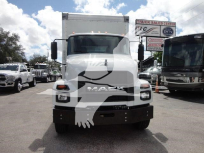 Front view of a white 2026 Mack MD6 box truck showing Mack grille and front bumper, with dealership lot in background.