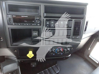 Dashboard and center console of a Mack MD6 truck showing radio, HVAC controls, and cupholders in a new condition cab interior.