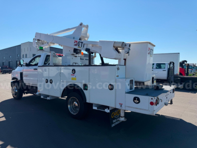 Service vehicle bucket truck with boom lift and utility compartments in white, side view showing buckets and stabilizers.