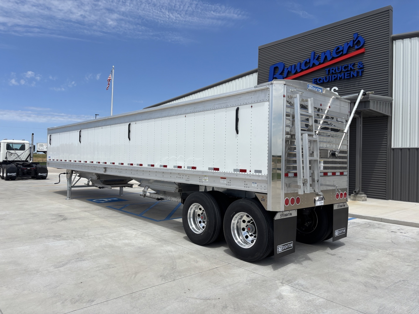 Trailer rear and side view of a 2027 Stoughton 42' aluminum grain hopper with 68" sides, dual rear axles, and ramp at the back.