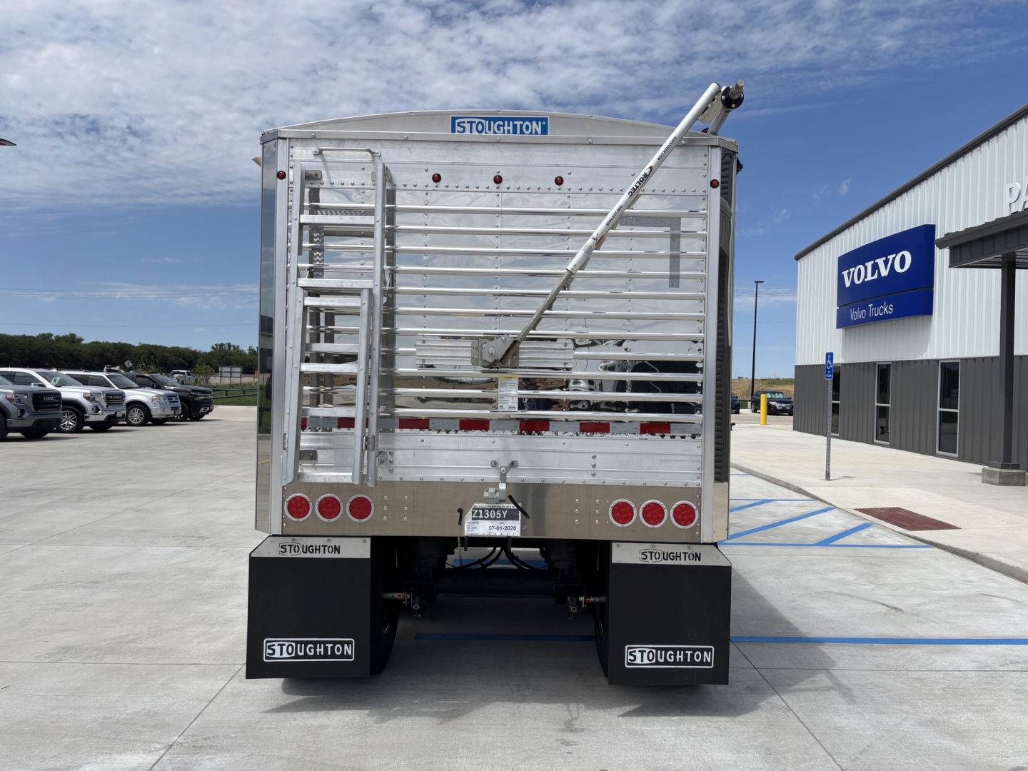 Rear view of a new 2027 Stoughton 42' aluminum grain hopper trailer with 68" sides, VIN 1DW1G4224VSC25827, stock 73343, showing Stoughton branding, ladders, and mud flaps.