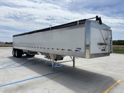 Stoughton 42' aluminum grain hopper trailer with 68" sides, in-service, viewed from front-right with tandems and hoist gates.