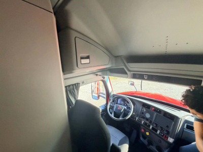 Kenworth T680 interior cab view showing steering wheel, dashboard, and driver seat; text not visible in the image.