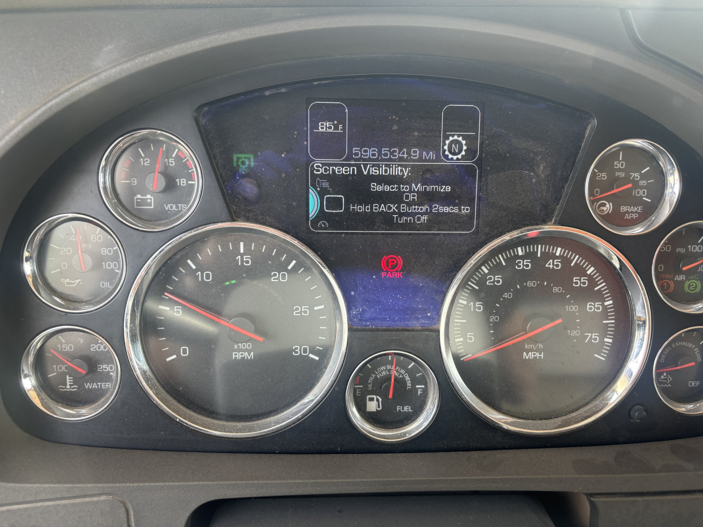 Kenworth T880 instrument cluster and center display showing gauges for RPM, speed, fuel, and warning icons in dashboard; VIN and truck info not visible.