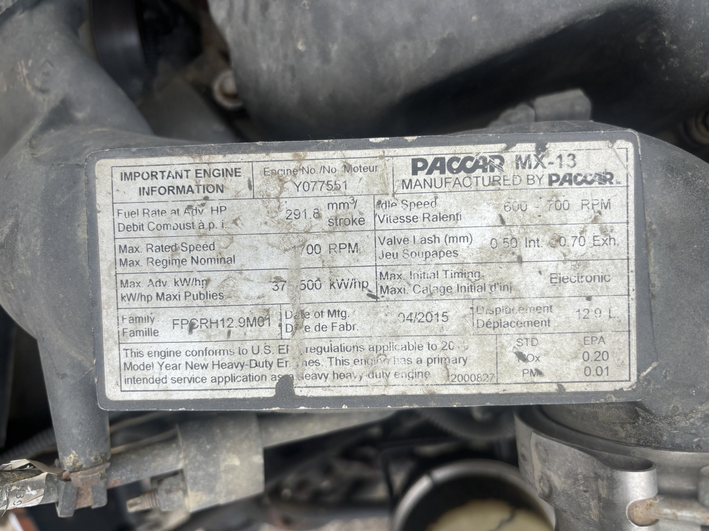 Label on engine with technical information for Paccar MX-13, showing fuel rate, engine speed, torque, and other specifications.