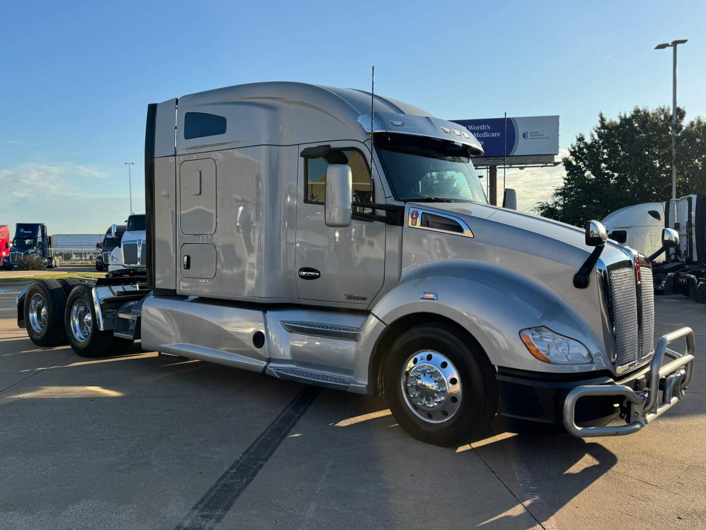 Kenworth T680 tractor-trailer side view showing chrome bumper and sleeper cab, with no text visible on the image.