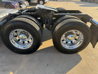 Kenworth T680 chassis showing dual rear wheels and chrome wheels, view of drive axles and frame, no cab visible.