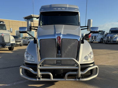 Kenworth T680 conventional sleeper truck front view showing grille, bumper guard, and chrome bull bar with decorative guards.