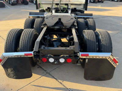 Kenworth T680 rear chassis showing dual rear axles and mud flaps.