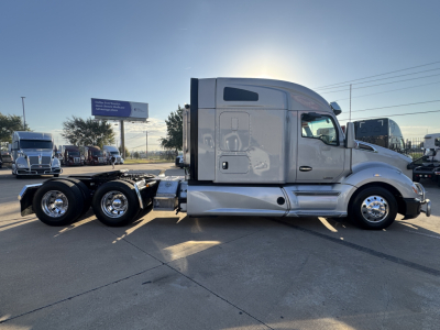 Kenworth T680 tractor-trailer side view showing aluminum cab and three rear axles with chrome wheels.
