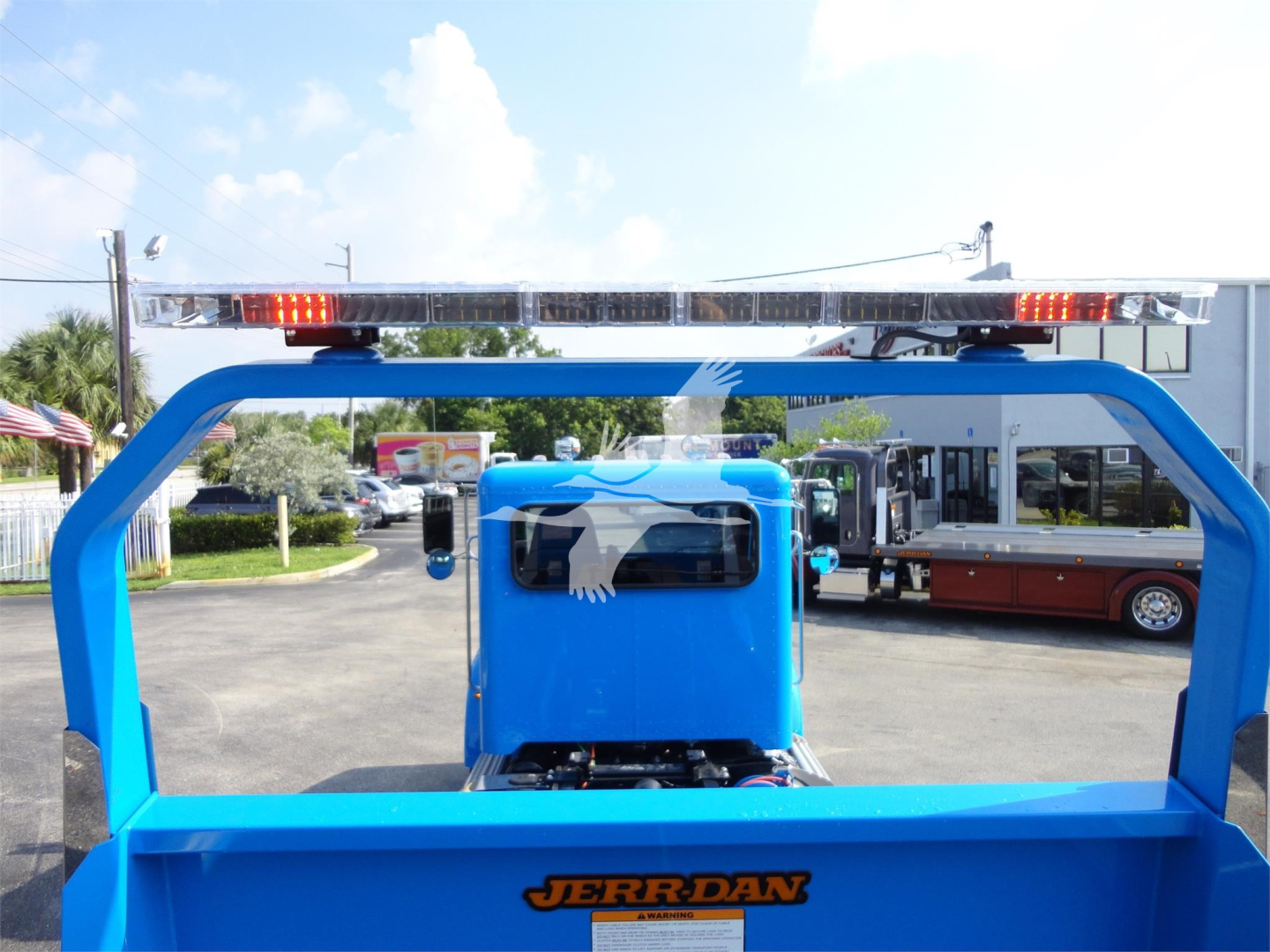 Truck rear/bed area of a 2022 Peterbilt 337 rollback truck showing blue frame and Jerr-Dan logo on the bed with a top light bar.