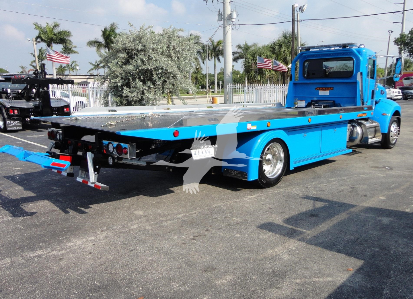 Peterbilt 337 rollback truck flatbed in blue, side view showing extended flatbed and rear hitch with taillights.