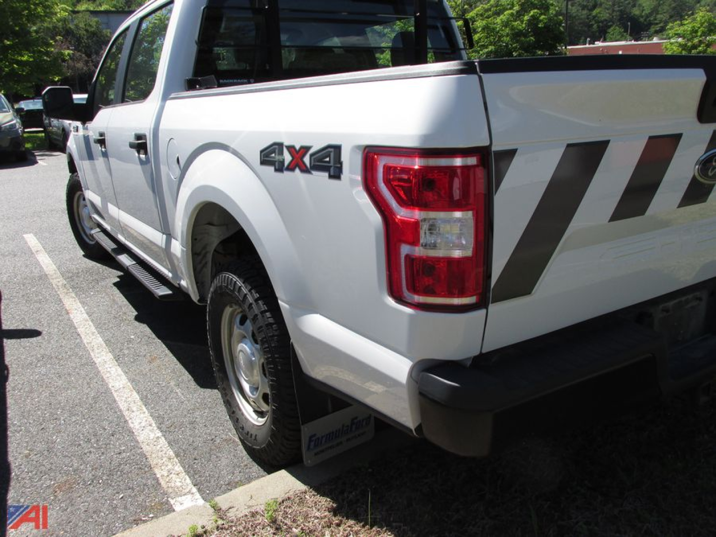 Ford F-150 pickup truck rear quarter view showing 4x4 badge on the side and tailgate design.