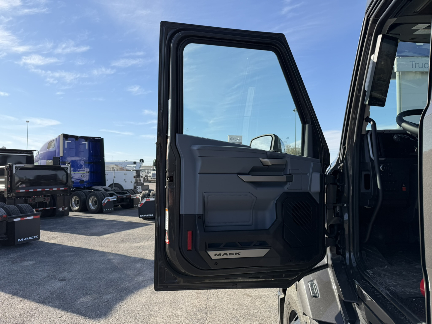 Mack PR64T76H truck cab door open showing interior door panel and 'MAK' badge