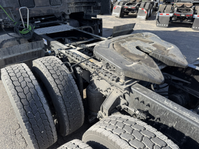 Mack PR64T76H tractor truck chassis and dual rear axles with fifth wheel housing, visible wear and dirt on tires and frame.