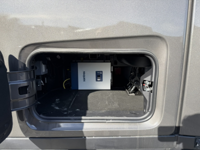 Front side-view of a Mack PR64T76H sleeper tractor fuel/electrical compartment showing a white device labeled 'SENSORIX' inside a recessed hatch.