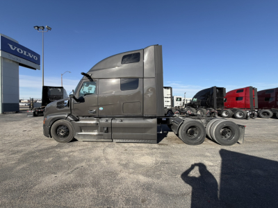 Mack PR64T76H conventional sleeper truck side view showing cab with elevated sleeper, fuel tanks, and rear wheel setup.