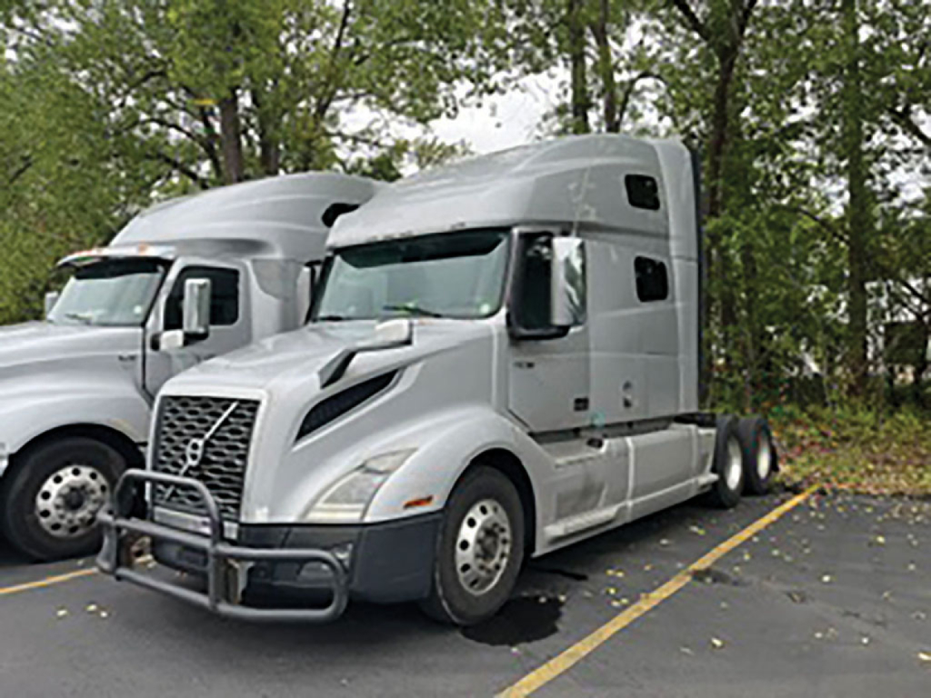 2019 Volvo VNL 760 truck in a parking lot, front-left view with a bumper guard and sleeper cab visible.