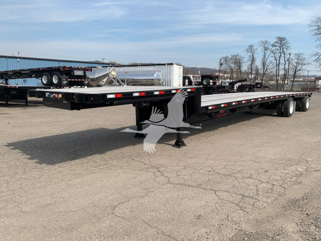 Trailer showing a long flatbed dropdeck with dual rear axles and landing gear. Visible text on stickers near the front shows VIN 7KYDF4829LED19283 and stock number 48-5983.