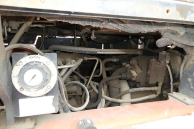 Truck lift engine bay showing hydraulic pump and hoses, left circular gauge, and wiring; 2018 Toyota THD3000-24 inventory image.