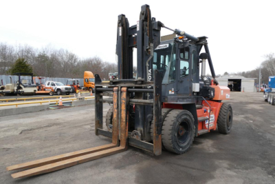 Toyota forklift with extended forks and lifted mast showing front view.